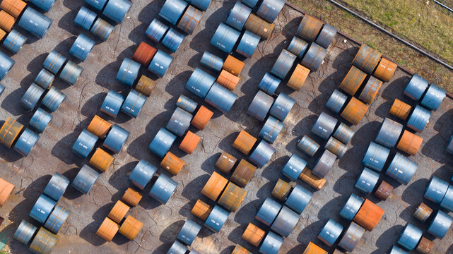 Aerial view of Tata Steel industrial site with rows of blue and rusty steel coils stored outdoors in Velsen-Noord, Noord-Holland, Netherlands.