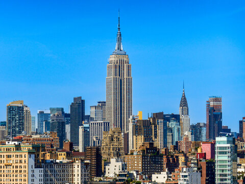 New York City, NY&mdash;June 16, 2018; The Empire State Building rises above the Manhattan skyline with the Chrysler Building visible to the east under clear summer skies.