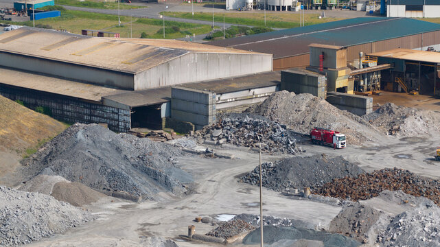 Aerial view of the Tata Steel industrial site with piles of scrap metal and large warehouses Velsen-Noord, Noord-Holland, Netherlands.