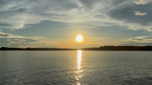 Golden sunset over the Amazon River seen from a boat in the Amazon rainforest during Amazonian winter