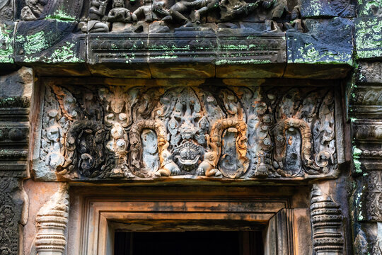 Intricately carved pink sandstone lintel at Banteay Srei temple.