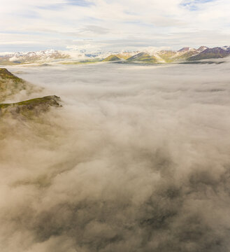 Aerial view of misty mountains surround ing the bay of Unalaska, Alaska, USA.