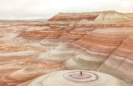 Aerial view of man standing on rock formations in Hanksville, Utah, USA.