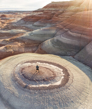 Aerial view of man standing on rock formations in Hanksville, Utah, USA.