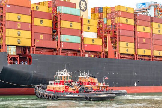 Boston, MA, US-April 25, 2026: Large international cargo ships in harbor  loaded with shipping containers.