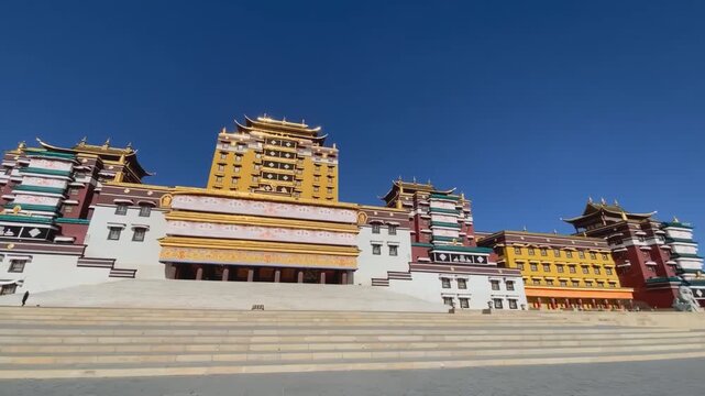 Panoramic front view of the vibrant Gomang Monastery near Ngawa in Amdo, showcasing magnificent Tibetan Buddhist architecture, ornate details and vivid colors.