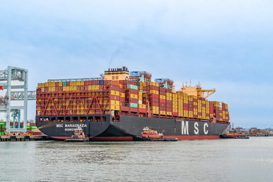 Boston, MA, US-April 25, 2026: Large international cargo ships in harbor  loaded with shipping containers.