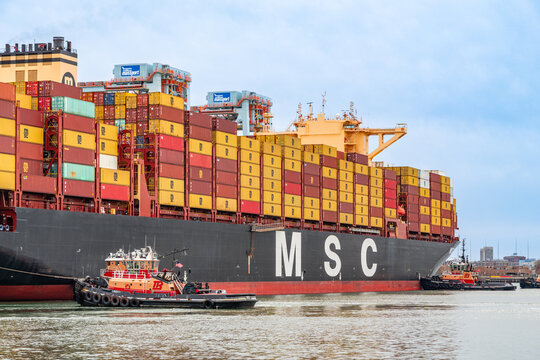 Boston, MA, US-April 25, 2026: Large international cargo ships in harbor  loaded with shipping containers.
