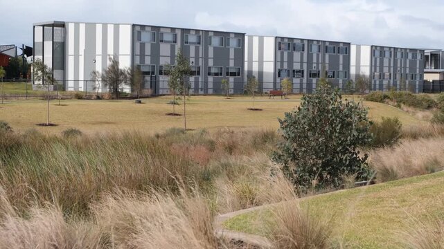 A modern public primary school building with modular architecture facility and its surrounding parkland in Tarneit. Educational services in an outer suburb of Melbourne Australia.