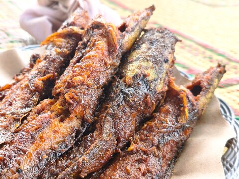 Delicious crispy fried catfish (Lele Goreng) served on a plate, a popular traditional Indonesian street food dish known for its savory and crunchy texture