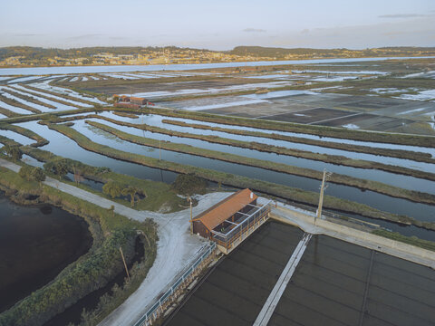 Aerial view of colorful salt marshes and serene wetland landscape with a winding path, Figueira da Foz, Coimbra, Portugal.