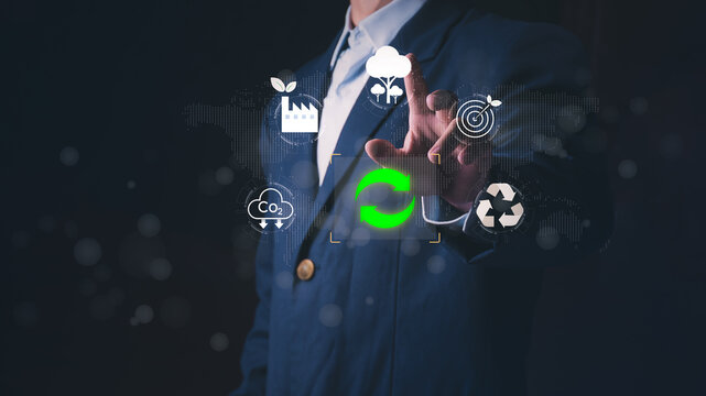 Professional businessman touching virtual screen with ESG for sustainable development. Concept of renewable energy, carbon neutrality, net zero emissions, and eco-friendly corporate strategy.