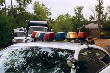 Police vehicle with lights on top parked near buildings during community event © ungvar