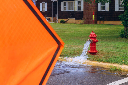 Water flows from fire hydrant leak on quiet street near residential homes