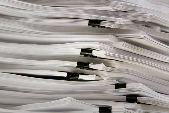 Pile of thick reports with fasteners