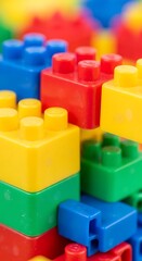 Fototapeta premium Colorful plastic building blocks closeup.