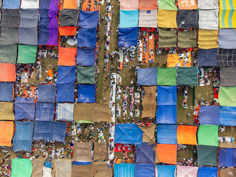 Tongi, Bangladesh - 31 January 2025: Aerial view of the Bishwa Ijtema gathering with thousands of people under colorful tarps and makeshift tents.