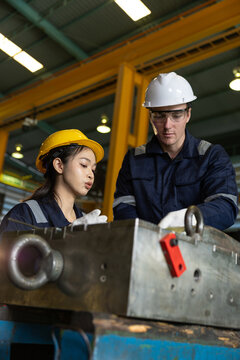 Factory engineer worker helmet safety teamwork inspection metal machinery Factory engineer worker helmet safety teamwork inspection metal machinery, industrial team workshop reviewing Vertical