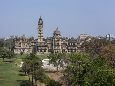 Vadodara, India - 14 March 2026: Aerial view of Laxmi Vilas Palace featuring its ornate Indo-Saracenic architecture, tall central tower, and lush green gardens under a clear sky.