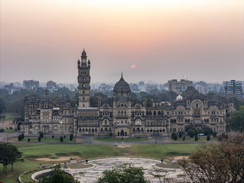 Vadodara, India - 14 March 2026: Aerial view of Laxmi Vilas Palace featuring its grand Indo-Saracenic architecture, ornate domes, and tall tower under a hazy sunset sky.