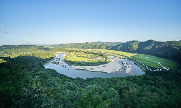 This captivating photo series showcases South Korea's Hoeryongpo village. It features a majestic panoramic view of the meandering river from Hoeryongdae and a unique steel bridge crossing the water.