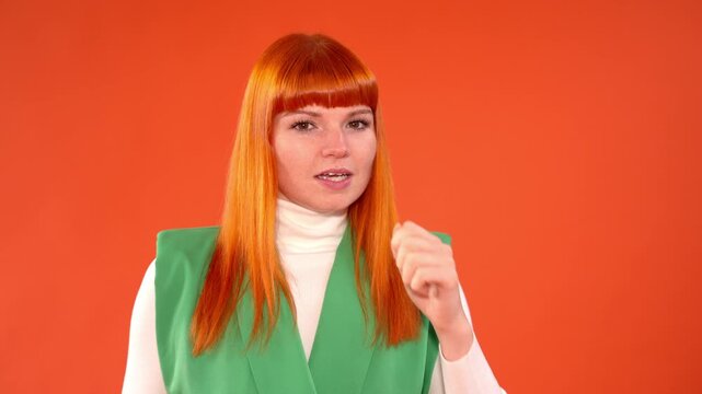 Woman showing different emotions as she coughs in front of an orange background