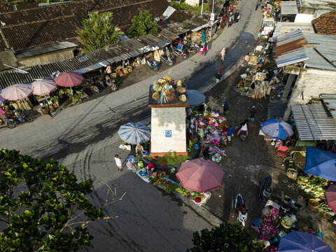 Klaten, Indonesia - 23 April 2026: Aerial view of Pasar Kembang Klaten traditional market with colorful umbrellas, street stalls, and local people.