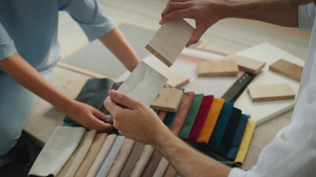 Interior design professionals choosing material swatches for home renovation project.