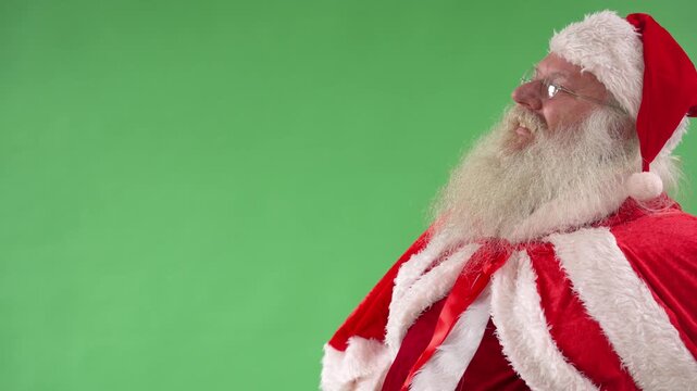 Santa Claus performs and shares joy in festive spirit with smiles and laughter at a green background setting