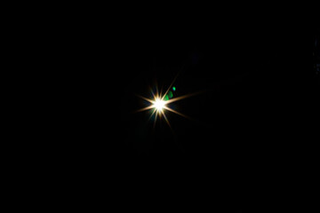 Fototapeta premium Symmetrical ten-point star flare with green chromatic aberration dots on a black background. Sharp geometric light burst for scientific or futuristic visuals.