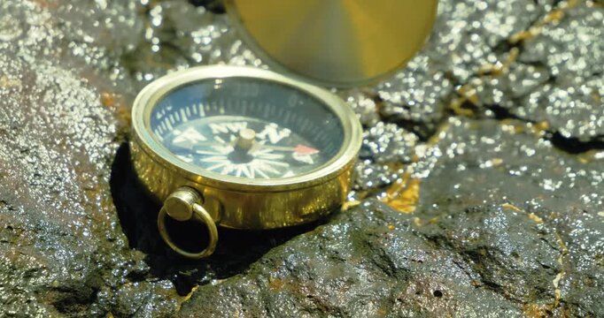 Compass on Rocky Surface in Sunlight Exploration