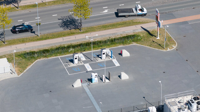 Utrecht, Netherlands - 29 April 2026: Aerial view of the LNG and hydrogen Tankstation Rolande featuring fuel pumps and designated parking spaces next to a busy road with passing vehicles.
