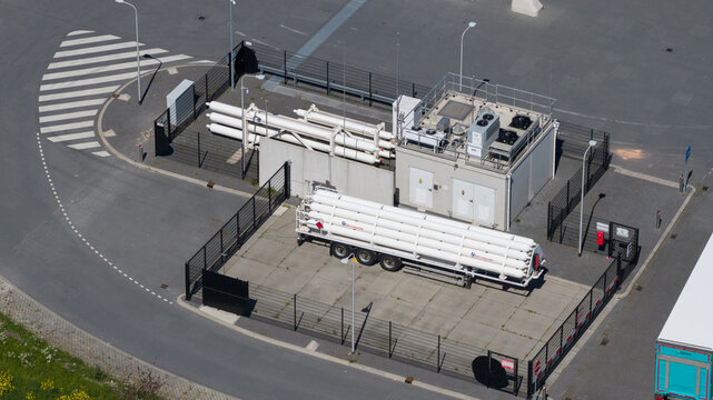 Utrecht, Netherlands - 29 April 2026: Aerial view of the LNG and hydrogen Tankstation Rolande featuring fuel pumps and designated parking spaces next to a busy road with passing vehicles.