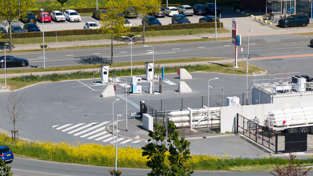 Utrecht, Netherlands - 29 April 2026: Aerial view of the LNG and hydrogen Tankstation Rolande featuring fuel pumps and designated parking spaces next to a busy road with passing vehicles.