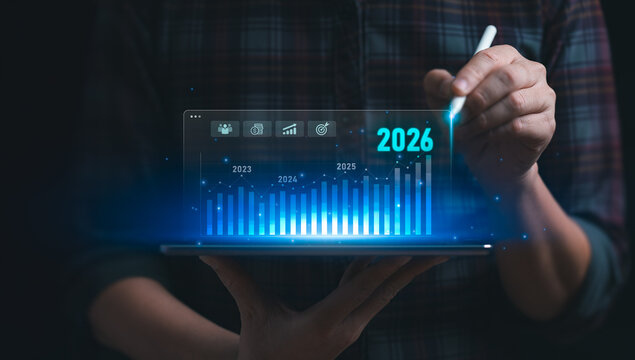 Digital business growth analysis concept with financial chart data visualization on tablet using stylus showing future forecast strategy planning and corporate performance trend for 2026