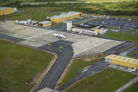 Waterford Regional Airport, Ireland - 02 July 2015: Aerial view of Waterford Airport featuring a small passenger aircraft on the apron, the control tower, and terminal building.