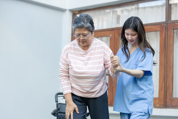 Naklejka premium Compassionate nurse acts as caregiver assisting senior patient to help walk through intense knee pain providing essential support and tender care during physical rehabilitation recovery process