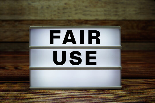 Lightbox with text "Fair Use" on wooden background