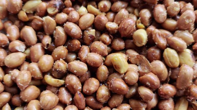 Macro Video of Fried Garlic Peanuts with Salt Crystals Traditional Crispy Snack