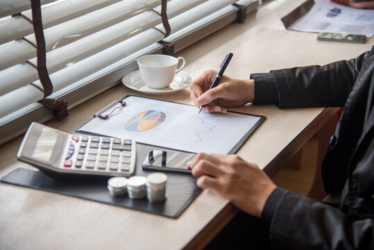 Close up businesswoman hands audit accountant using calculator, business graph chart working at home office. Woman Hands working home do accounting small business. Audit Businesswoman at office desk