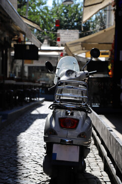 A white scooter parked on a street