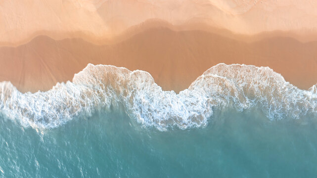Tropical beach landscape from drone perspective showing turquoise sea and smooth sand coastline. Minimal natural background ideal for travel websites, resort promotions, and summer design projects.