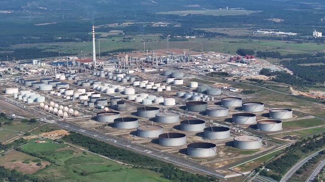 Experience the intricate workings of a petroleum refinery, showcasing vast storage tanks and advanced industrial structures that convert crude oil into valuable fuels and products.