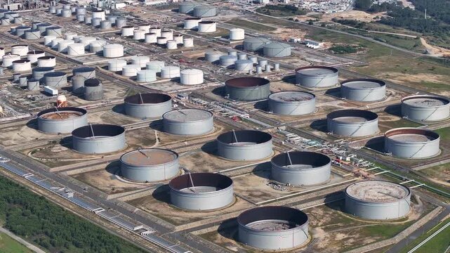 Aerial views showcase the extensive layout of a petroleum refinery featuring large storage tanks and processing facilities. This complex plays a key role in crude oil conversion and fuel production.