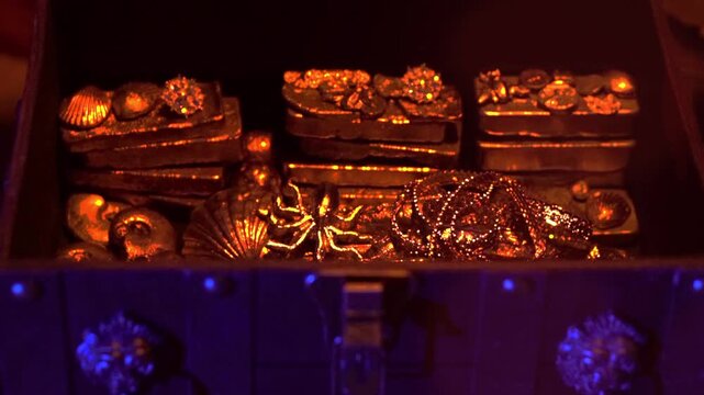 A treasure chest filled with gold ingots and valuables.