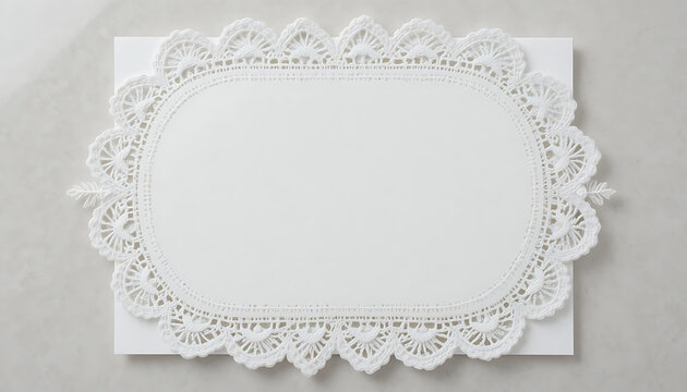 Elegant white lace doily on a rectangular piece of paper with intricate floral patterns and delicate edges on a light gray background