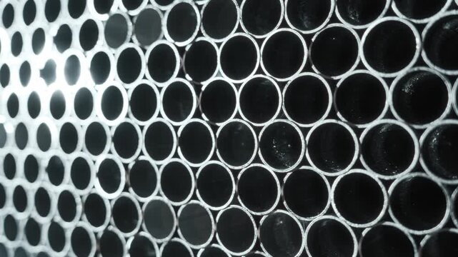 Close View Of Closely Packed Metal Tubes. Highcontrast Image Of Aluminum Pipes Organized For Shipment