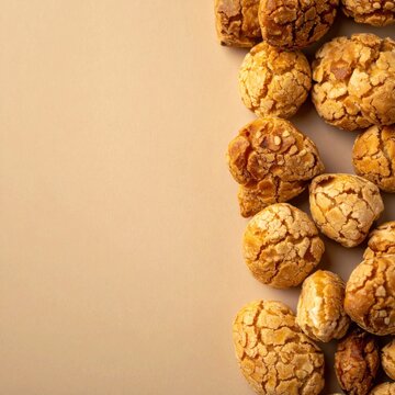 golden brown crunchy choux pastry balls arranged on a textured beige surface providing ample copy space for culinary designs