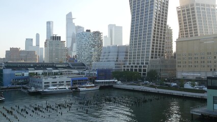 Obraz premium New York City Hudson yards and Chelsea urban view from Little Island pier park, Midtown of Manhattan, United States. Waterfront building architecture, skyline cityscape in USA, NYC west side district.