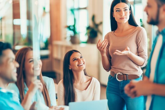 Woman presenting ideas to colleagues in office